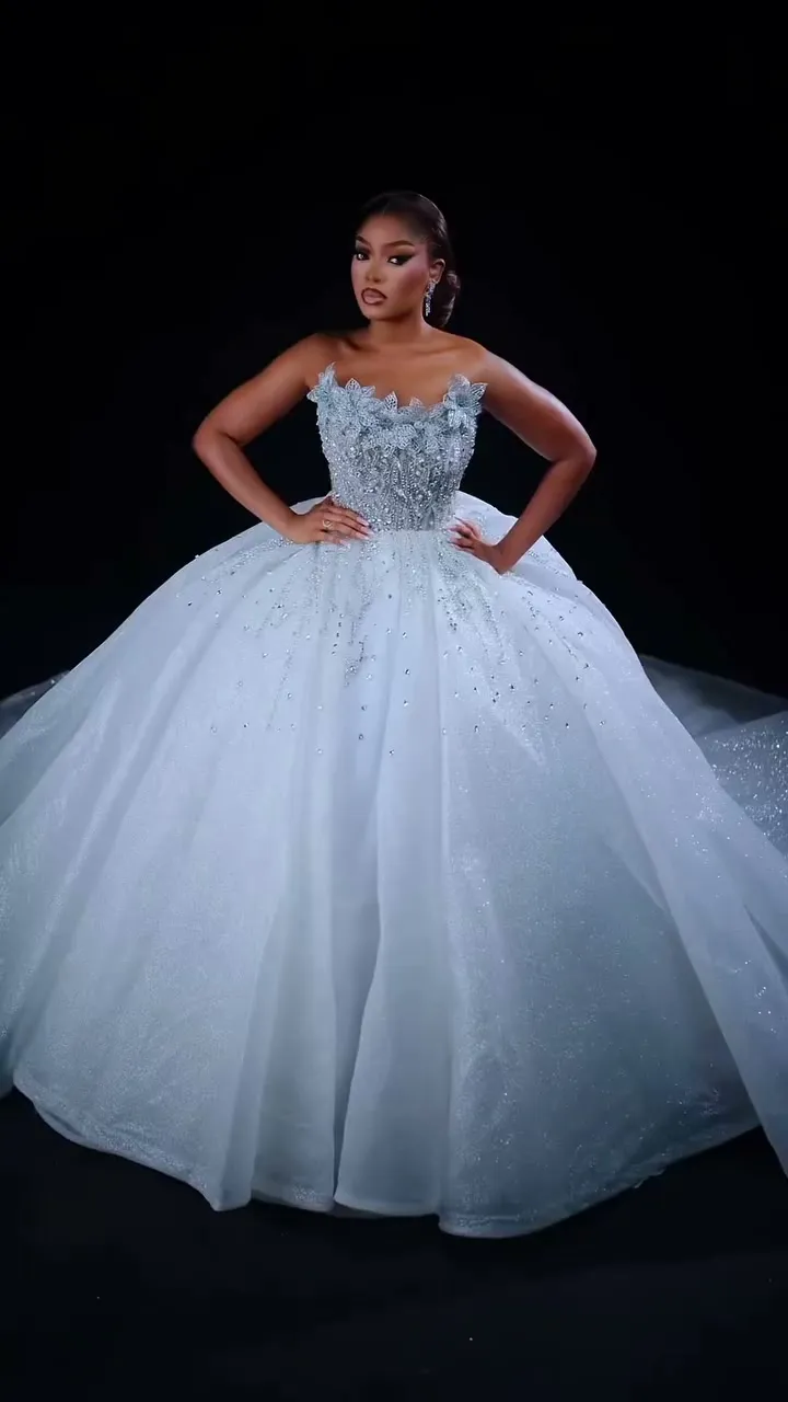 The Look II ball gown from the side, on a dark set