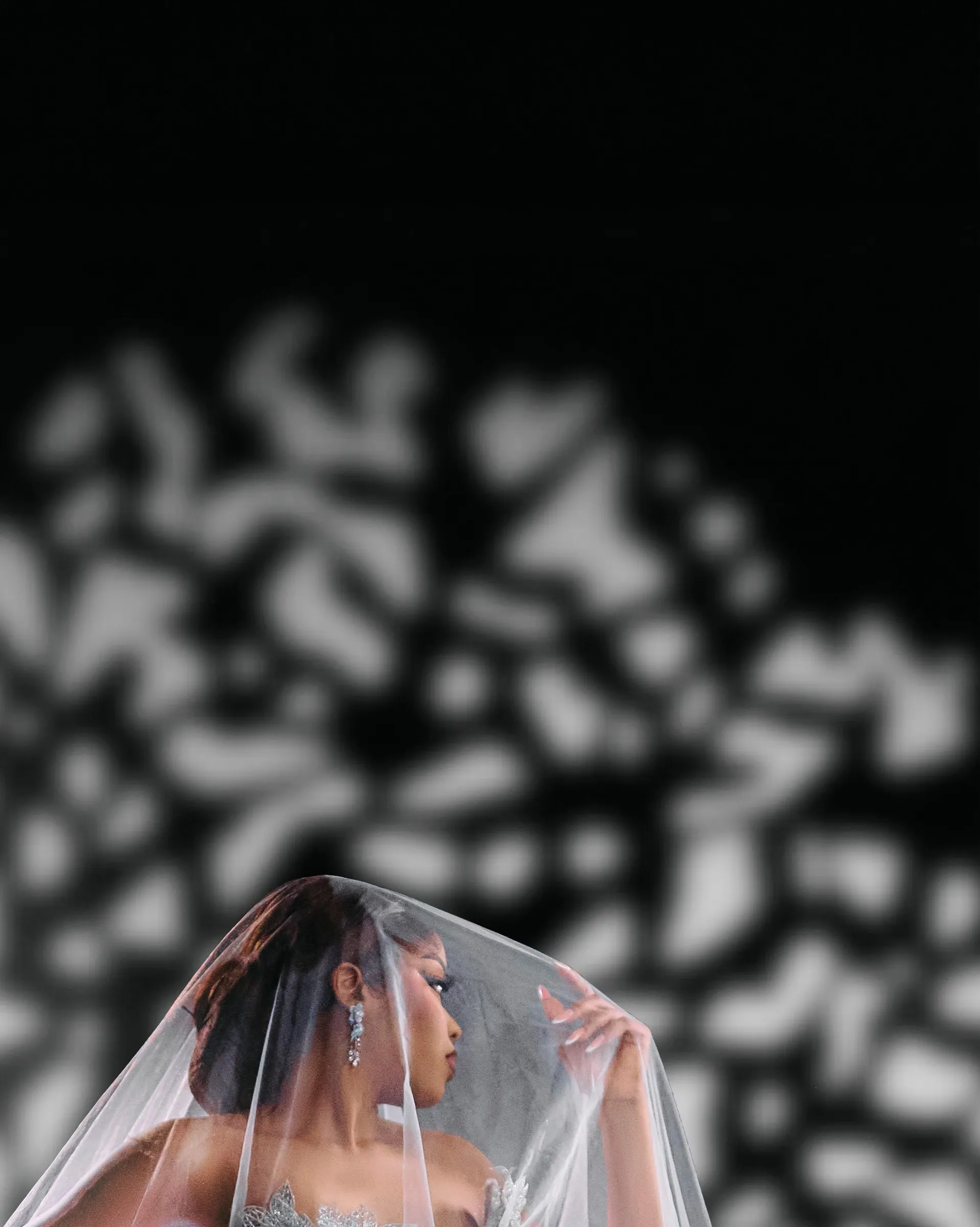 A bride looking through a sheer cathedral veil