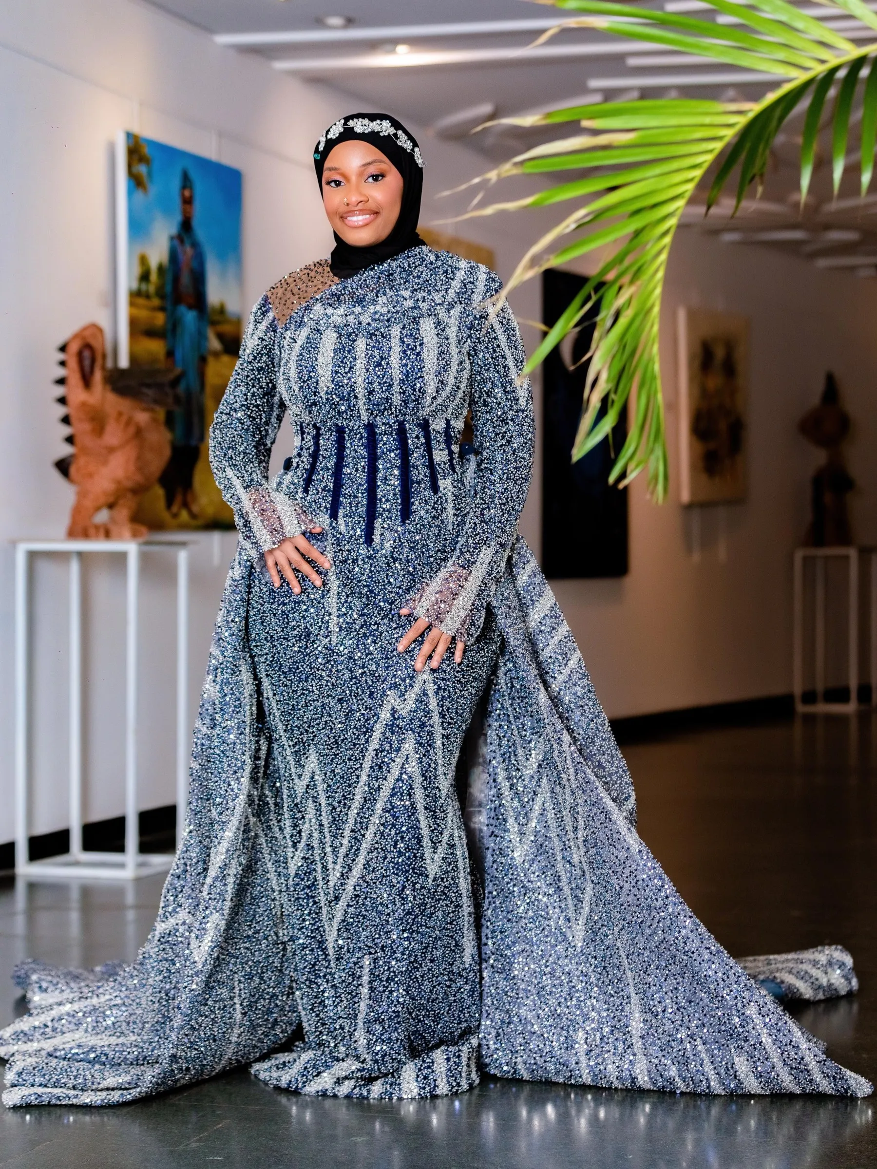 The silver beaded gown with a cape, on a mannequin in the studio